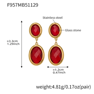 Detailed view of 18k gold plated stainless steel earrings with red faceted glass stones