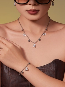 Detail of silver bear and heart jewelry set with 5A zircons worn by a model