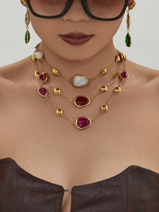 Detailed view of layered 18k gold plated necklace and earrings with colorful resin stones
