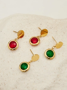 Detailed shot of 18k gold plated earrings with faceted red and green glass stones