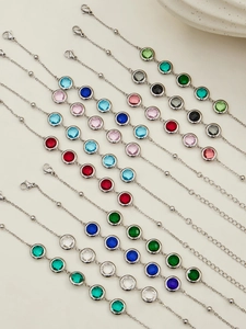 Close-up of colorful faceted glass stone bracelets in polished stainless steel settings