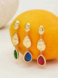 Detail of 18k gold plated drop earrings with faceted emerald, sapphire, and ruby glass stones