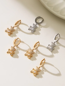 Macro detail of bear hoop earrings with sparkling zircon pave and heart stones