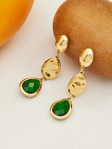 Detailed macro of gold plated stainless steel earrings with emerald green pear-cut stones