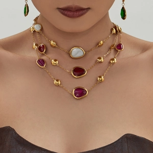 Three-layer gold necklace set with irregular white and red resin gemstones and earrings
