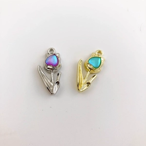 Detail of tulip pendants with heart crystals in silver and gold plating for jewelry DIY