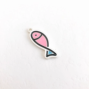 Detailed macro view of a cute pink fish pendant with blue accents for DIY jewelry making