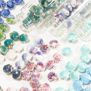 Macro shot of seashell-shaped ceramic beads for DIY jewelry making in assorted sea colors