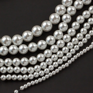Polished white acrylic faux pearls in various sizes for DIY jewelry and crafts