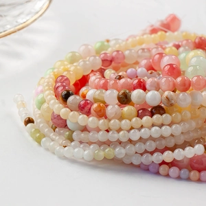 Close-up of colorful round gemstone beads for DIY jewelry making with smooth texture