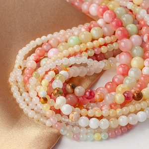 Close-up of colorful round natural stone beads in mixed candy colors for DIY jewelry