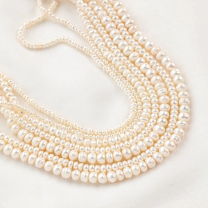 Strands of natural freshwater baroque pearls in creamy white for DIY jewelry making