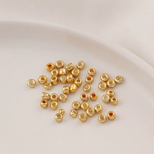 Close-up of golden metallic glass spacer beads for DIY jewelry making and crafts