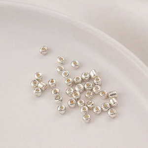 Close-up of polished silver plated glass wheel spacer beads for DIY jewelry making