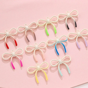 Close-up of macaron color enamel alloy bow pendants for DIY jewelry and accessories