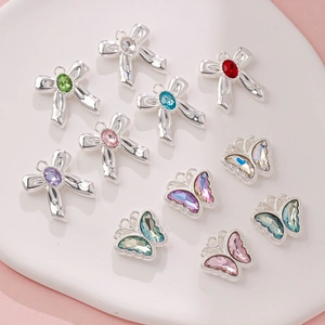 Macro view of macaron alloy bow pendants with colorful rhinestones for DIY jewelry