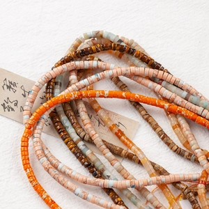 Macro view of sunset orange and multicolor natural stone rondelle beads for jewelry DIY