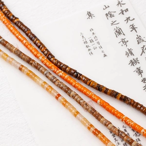 Detailed close-up of sunset orange natural stone 4x2mm flat rondelle beads for DIY jewelry
