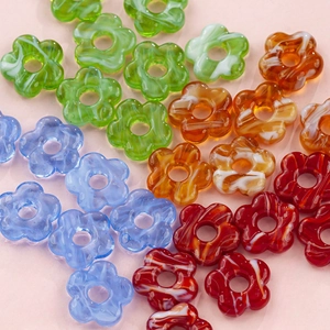 Macro view of 16mm hollow glass flower beads for DIY jewelry making in various colors