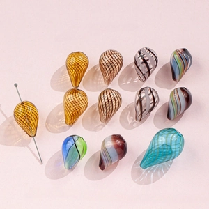 Close-up of handmade irregular striped glass waterdrop beads for jewelry making