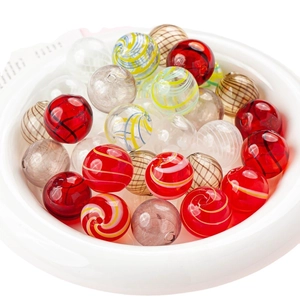 Colorful retro textured glass hollow beads in a white bowl for DIY jewelry making
