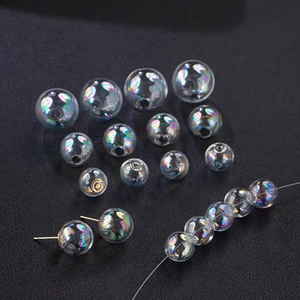 Iridescent glass bubble beads and stud earrings with rainbow effect on dark background