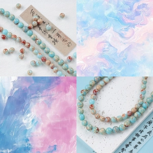 Detail of natural blue-green stone beads with mineral textures on a textured display