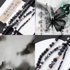 Detail of natural zebra stone round beads with black and white marble patterns for DIY jewelry
