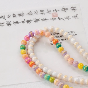 Macro shot of 6-8mm colorful jade beads with gold foil accents for DIY jewelry making