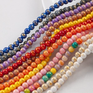 Macro detail of colorful 8mm round glass beads with gold foil and marble textures for DIY