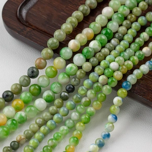 Macro detail of natural green jadeite round beads with oily luster for DIY jewelry making