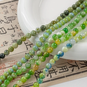 Detail of green natural jade beads with gradient textures for DIY jewelry making
