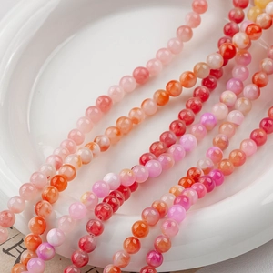 Macro shot of 4-12mm pink natural jade round beads for DIY jewelry making accessories