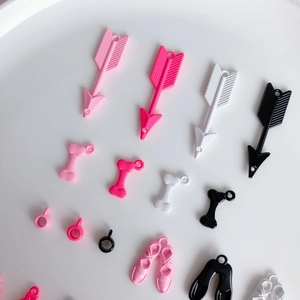 Pink and black DIY dopamine charms including mini ballet shoes and arrows for jewelry making