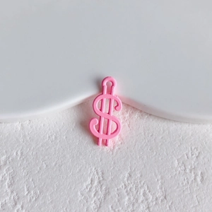 Close-up of pink matte dollar sign pendant for DIY jewelry making and accessories