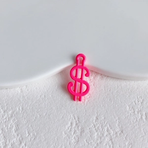 Close-up of hot pink dollar sign charm with hanging hole for DIY jewelry making and crafts