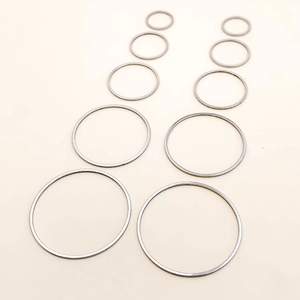Detailed view of ten smooth stainless steel circular pendants in graduated sizes for DIY jewelry