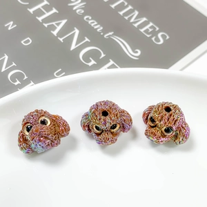 Detailed macro view of three iridescent brown poodle beads for DIY jewelry making