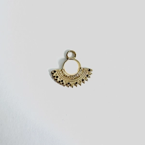 Detail of fan-shaped stainless steel pendant with gold plating and hollow filigree design