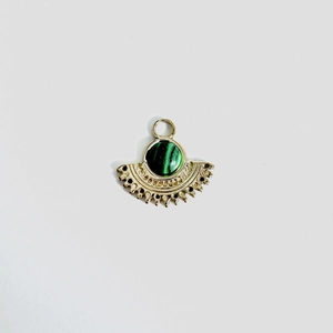 Detailed view of fan-shaped golden pendant with a malachite stone inlay and retro carvings