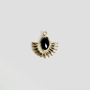 Detail of fan-shaped stainless steel pendant with black oval stone and sunburst pattern