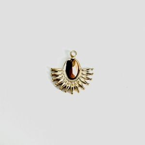 Detail of fan-shaped gold stainless steel pendant with oval tiger eye stone inlay
