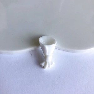 Macro detail of white resin floral bouquet charm for DIY jewelry and crafts making