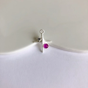 Detailed view of silver star cross pendant with rose red gem for DIY jewelry making