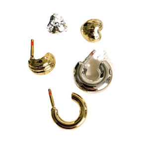 Polished gold and silver C-shaped metal hoop earrings with heart shapes in various designs