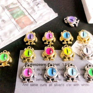 Detailed close-up of colorful robot monster alloy charms for DIY jewelry making