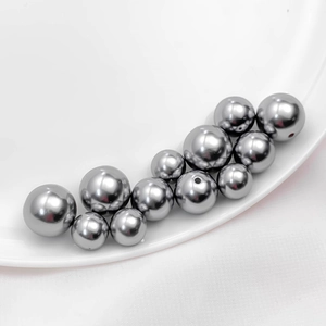 Detailed view of glossy grey acrylic pearl beads with drill holes for DIY jewelry