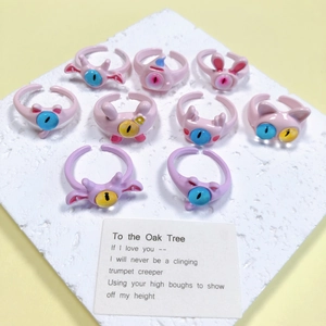 Detailoverzicht van schattige hars monsterringen in roze en paarse pastelkleuren
