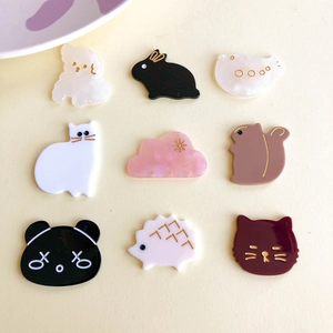Flat lay of colorful acrylic cartoon animal charms for DIY hair accessories and jewelry