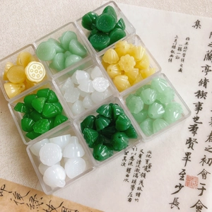 Flat lay of colorful lotus pod glass beads in a 9-grid storage box for DIY jewelry